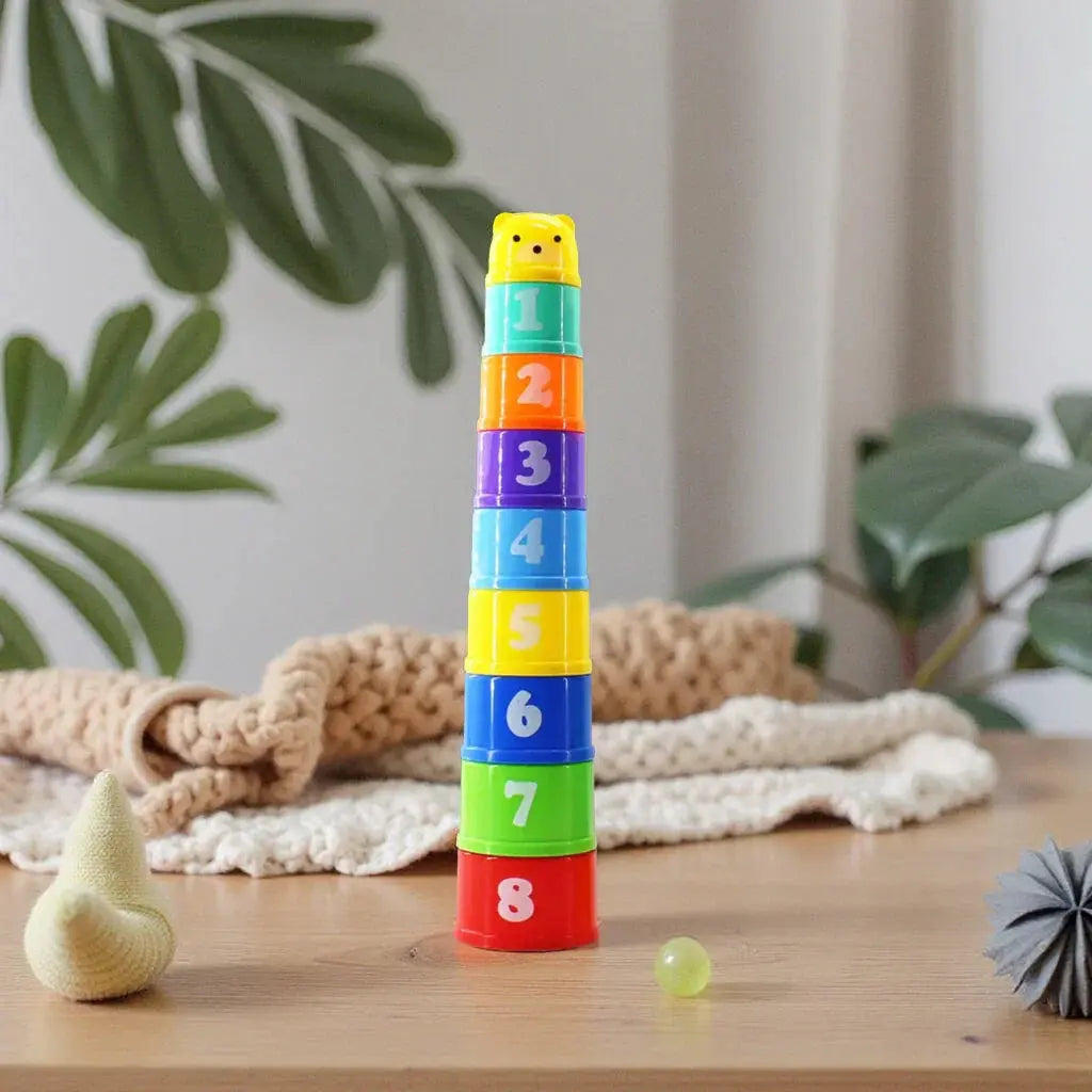 Colorful sensory stackable toy with numbers on a wooden surface with plants in the background