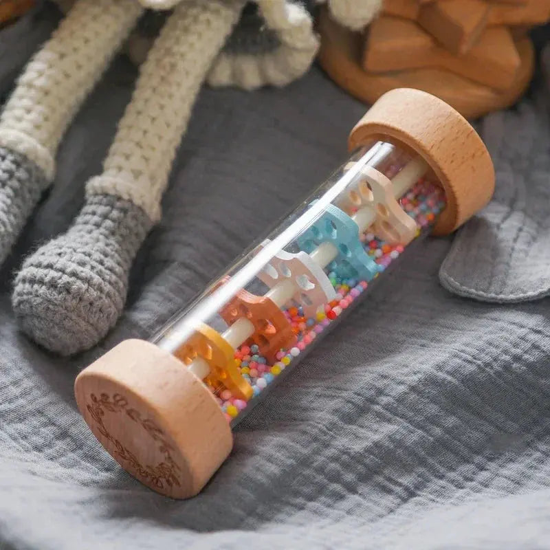 Toy with colorful beads and wooden wheels on a textured surface