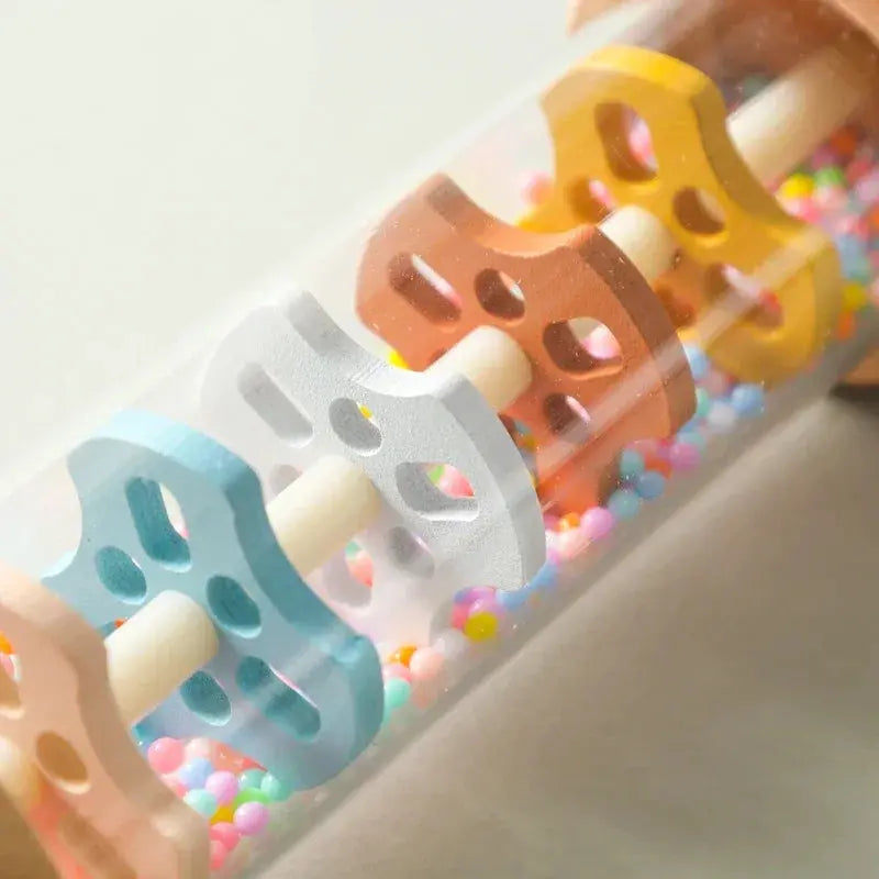 Colorful plastic rollers with holes on a white background