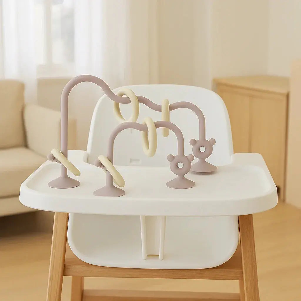 Children's high chair with a sensory toy attached in a room setting