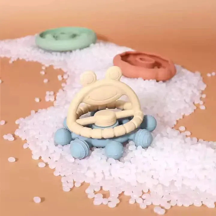 Teething toy with blue and beige design on a white surface